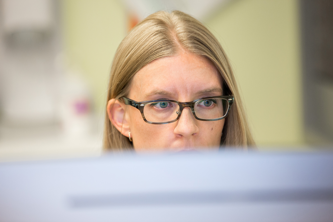 Employee with glasses looking at a screen