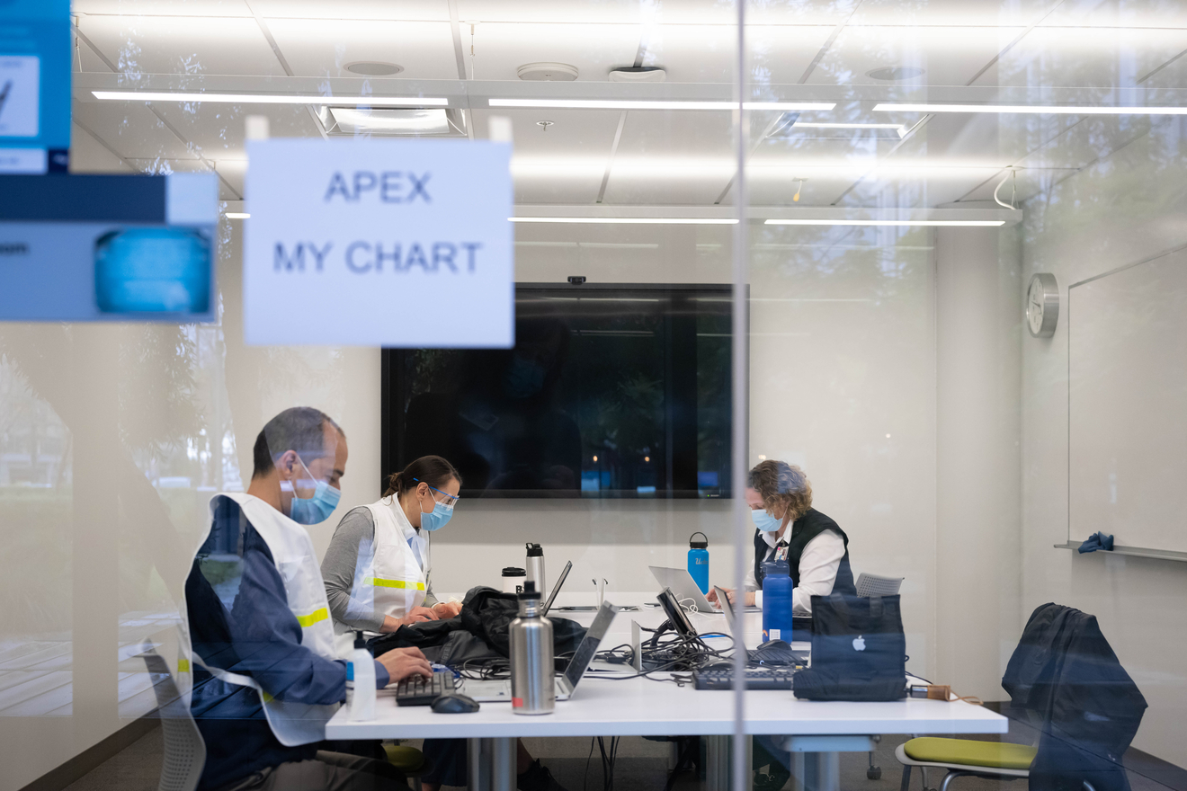 Employees working in the APEX My Chart-dedicated conference room